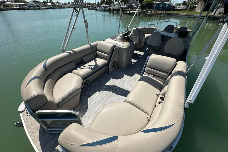 Slide: The Image of 2015 Berkshire 250E Premium pontoon boat with spacious seating on calm water. - 7