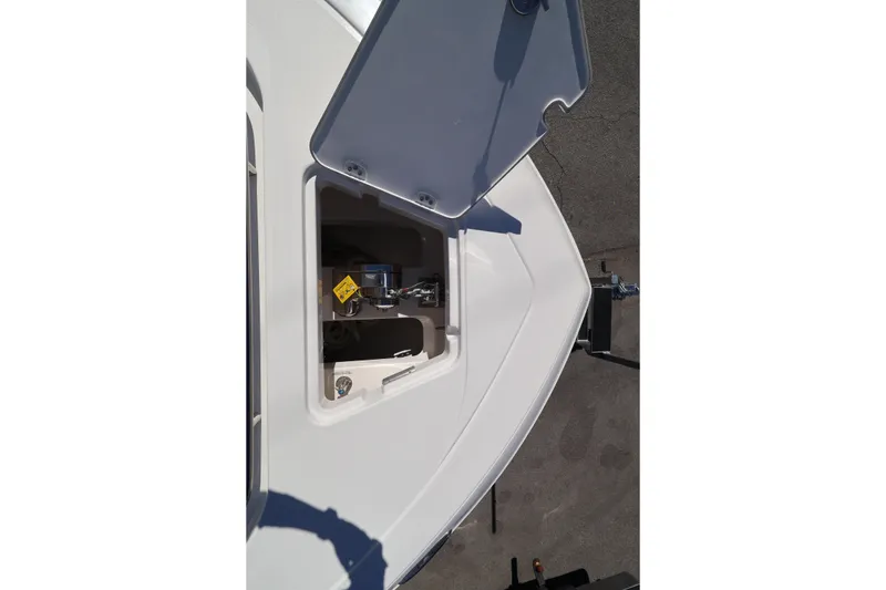 Slide: The Image of Open hatch on 2026 Caymas 291 boat, revealing interior compartment details. - 13