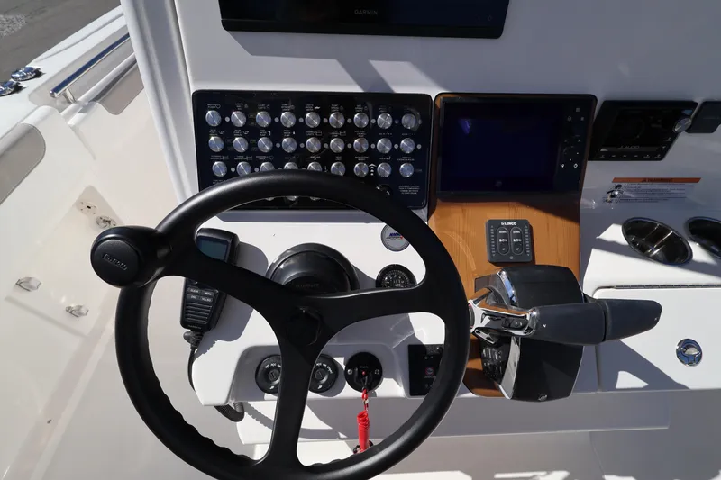 Slide: The Image of Steering console of 2026 Caymas 291 boat with controls and navigation equipment. - 16