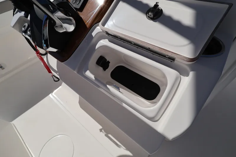 Slide: The Image of Open storage compartment on 2026 Caymas 291 boat, featuring sleek design and modern controls. - 17