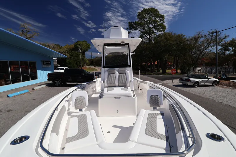Slide: The Image of 2026 Caymas 291 boat with sleek design and spacious seating, parked outdoors. - 18
