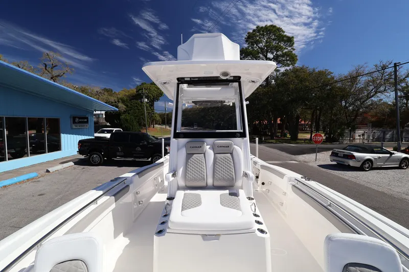 Slide: The Image of 2026 Caymas 291 boat with sleek design, parked outdoors under a clear blue sky. - 19