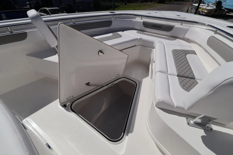 Slide: The Image of 2026 Caymas 291 boat interior with open storage compartment and cushioned seating. - 21