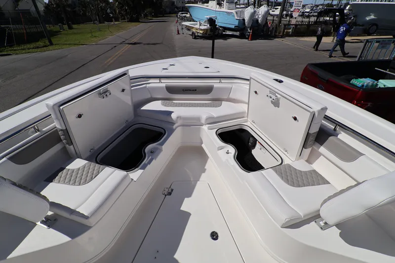Slide: The Image of 2026 Caymas 291 boat interior with open storage compartments and cushioned seating. - 22