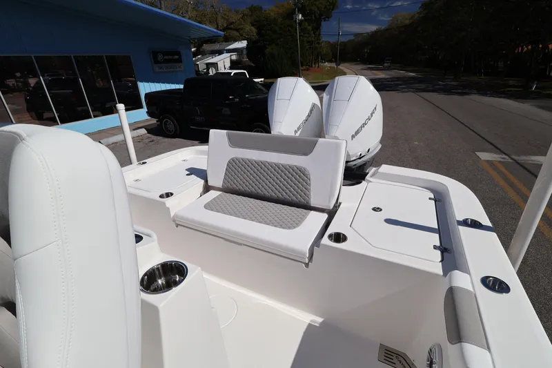 Slide: The Image of 2026 Caymas 291 boat with dual Mercury engines, white seating, and cup holders. - 29