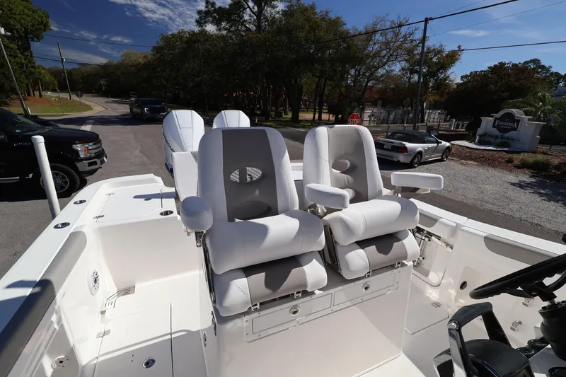 Slide: The Image of 2026 Caymas 291 boat interior with plush white seating and modern controls. - 30