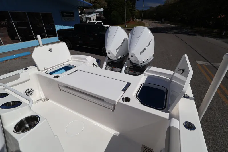 Slide: The Image of 2026 Caymas 291 boat with dual Mercury engines, open compartments, and sleek design. - 31