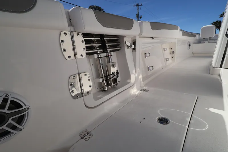 Slide: The Image of 2026 Caymas 291 boat interior with storage compartments and speaker system. - 35