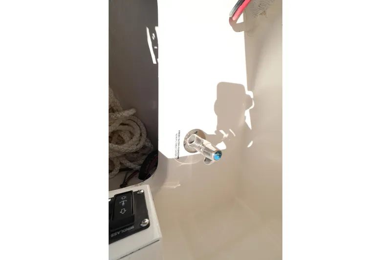 Slide: The Image of Interior detail of 2026 Caymas 291 boat, featuring a control panel and coiled rope. - 36