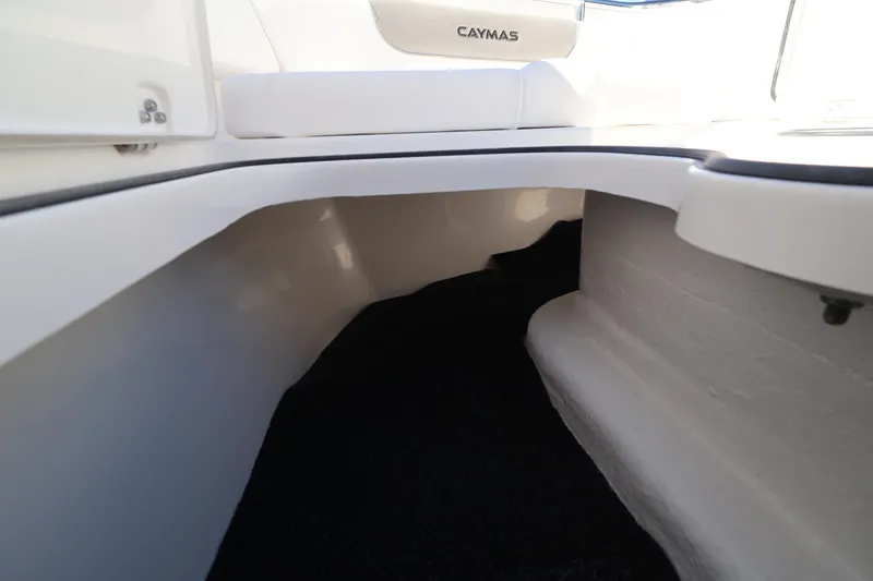 Slide: The Image of 2026 Caymas 291 boat interior storage compartment with sleek white finish. - 37