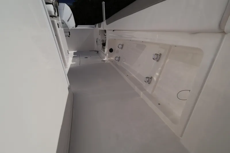 Slide: The Image of 2026 Caymas 291 boat interior with sleek white deck and storage compartments. - 42