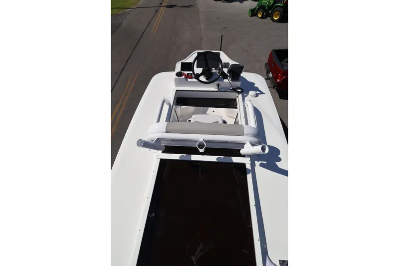 Slide: The Image of 2026 Caymas 291 boat, top view of helm and seating area on a sunny day. - 45