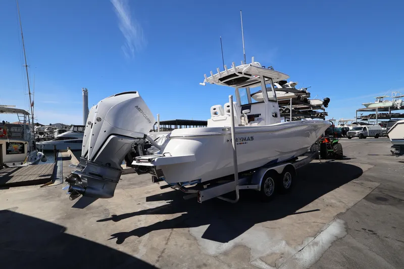 Slide: The Image of 2026 Caymas 291 boat on trailer at marina, featuring powerful Mercury outboard engine. - 5
