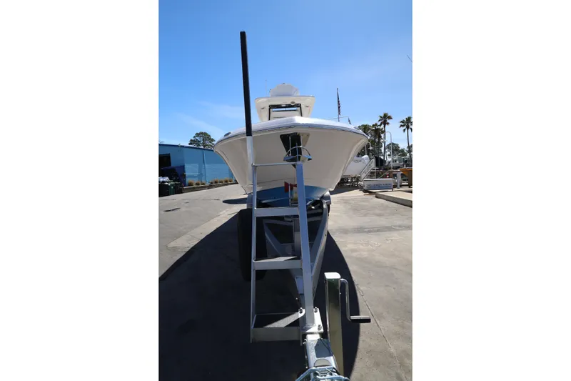 Slide: The Image of 2026 Caymas 291 boat on trailer in sunny marina setting. - 6