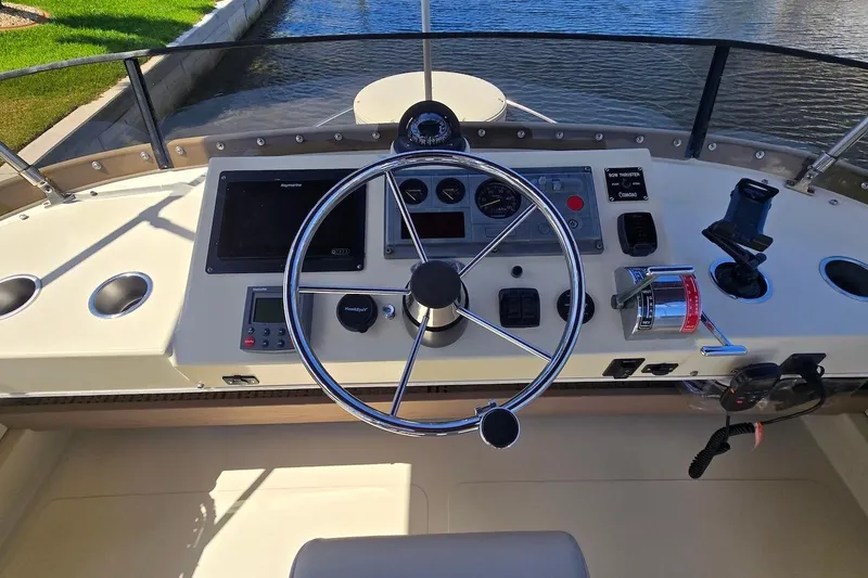 Slide: The Image of Helm of 2005 Camano 31 Troll boat with steering wheel and navigation controls. - 13
