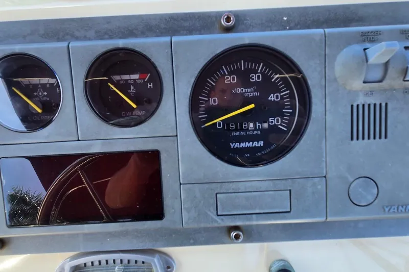 Slide: The Image of Dashboard of a 2005 Camano 31 Troll boat showing engine gauges and controls. - 15