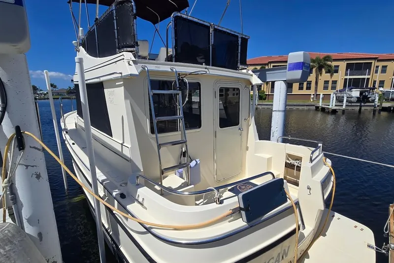 Slide: The Image of 2005 Camano 31 Troll boat docked at marina under clear blue sky. - 16