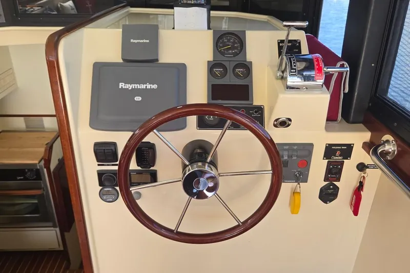 Slide: The Image of 2005 Camano 31 Troll helm with Raymarine navigation and control panel. - 22