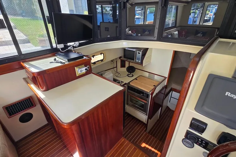 Slide: The Image of Interior of 2005 Camano 31 Troll boat with kitchen and navigation equipment. - 23
