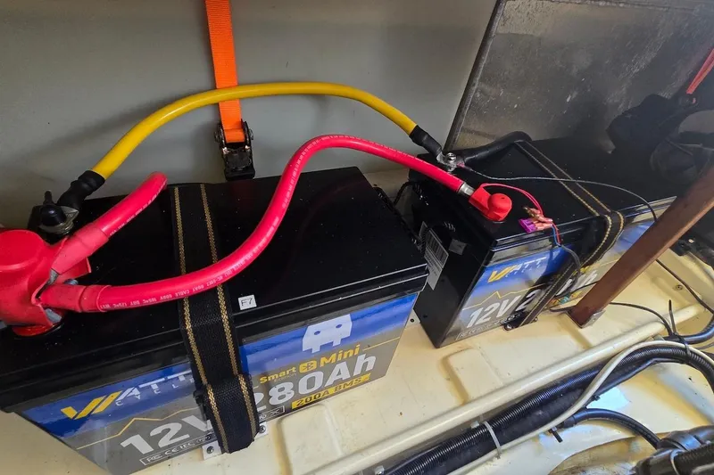 Slide: The Image of Batteries in a 2005 Camano 31 Troll boat, connected with red and yellow cables. - 32