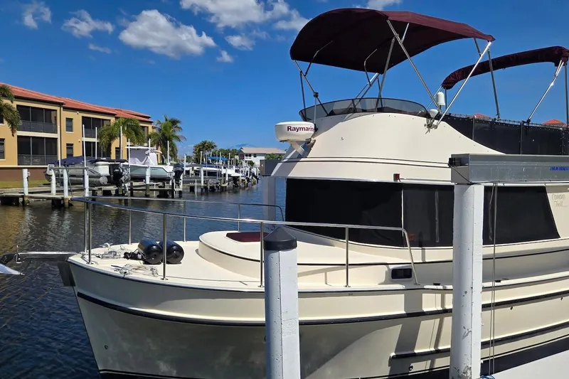 Slide: The Image of 2005 Camano 31 Troll boat docked in a sunny marina setting. - 9