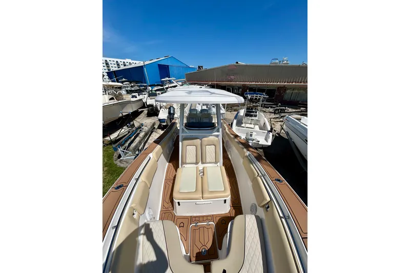 Slide: The Image of 2017 Seafox 288 Commander boat with tan seating, docked under clear blue sky. - 11