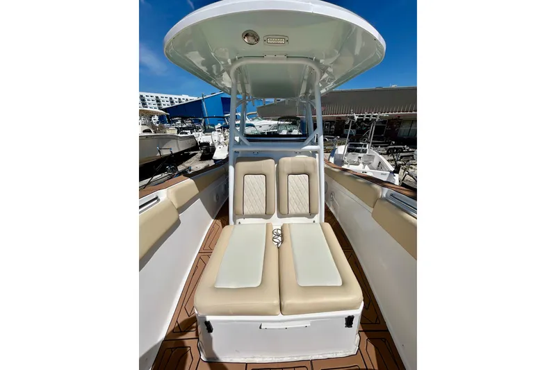 Slide: The Image of 2017 Seafox 288 Commander boat interior with cushioned seating and overhead canopy. - 12