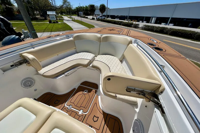 Slide: The Image of 2017 Seafox 288 Commander boat with beige seating and wood-patterned flooring. - 17