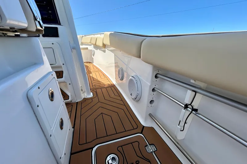 Slide: The Image of 2017 Seafox 288 Commander boat interior with cushioned seating and teak-style flooring. - 18