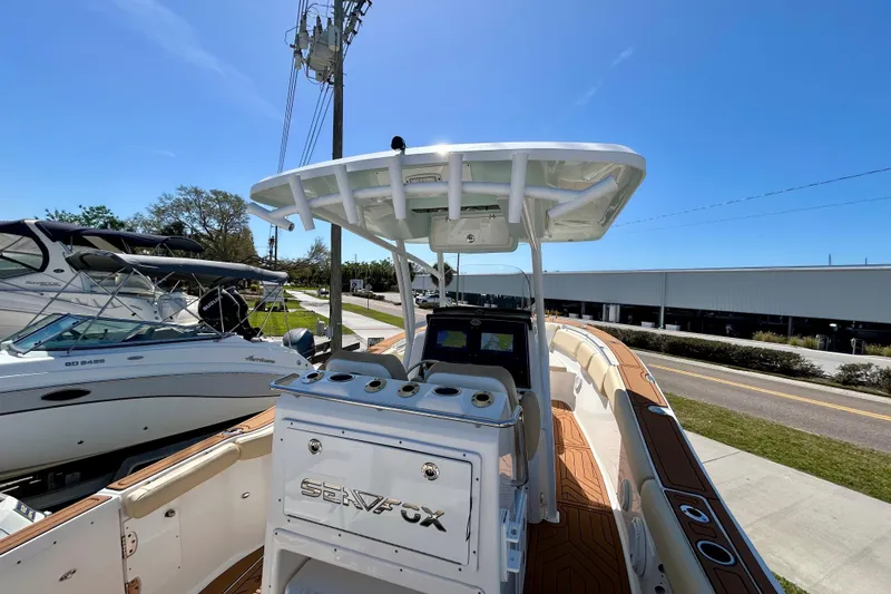Slide: The Image of 2017 Seafox 288 Commander boat with T-top, docked under clear blue sky. - 19