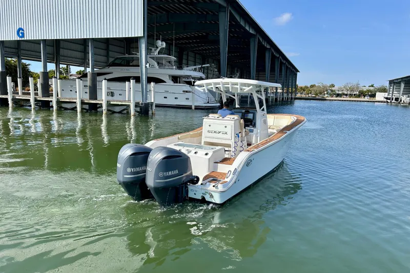 Slide: The Image of 2017 Seafox 288 Commander boat with twin Yamaha engines in a marina setting. - 2