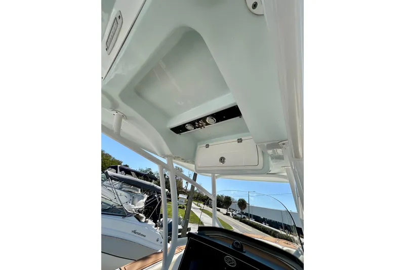 Slide: The Image of 2017 Seafox 288 Commander boat interior view, showcasing overhead storage and control panel. - 20