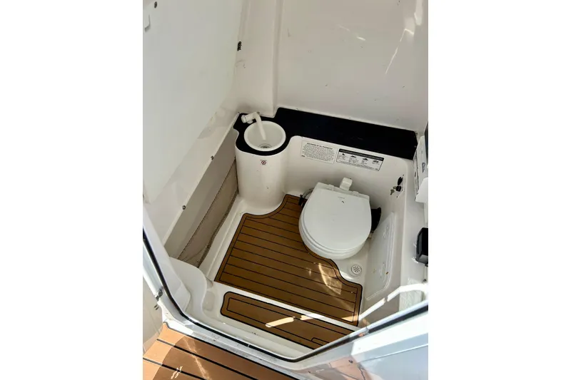 Slide: The Image of 2017 Seafox 288 Commander boat bathroom with wooden floor and compact toilet. - 23