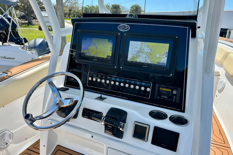 Slide: The Image of 2017 Seafox 288 Commander boat dashboard with dual navigation screens and steering wheel. - 4