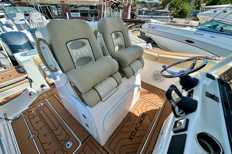 Slide: The Image of 2017 Seafox 288 Commander boat interior with dual seats and steering wheel. - 5