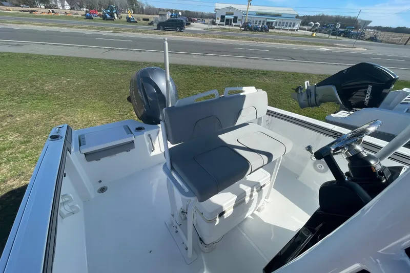 Slide: The Image of 2022 Wellcraft 202 Fisherman boat interior with seating and steering wheel. - 17