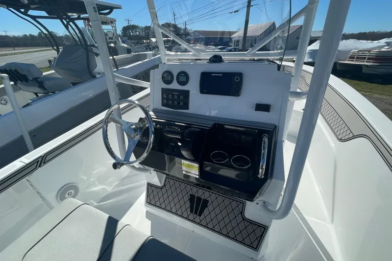 Slide: The Image of 2022 Wellcraft 202 Fisherman boat console with steering wheel and navigation controls. - 18