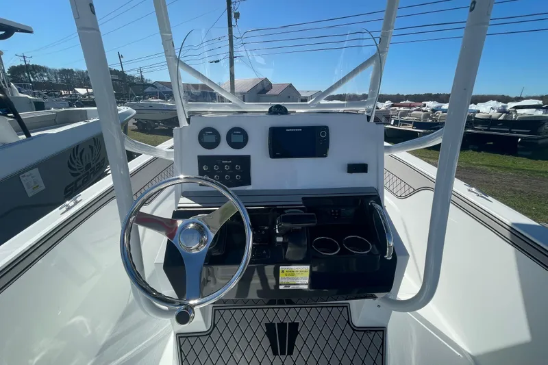 Slide: The Image of 2022 Wellcraft 202 Fisherman boat dashboard with steering wheel and controls. - 20