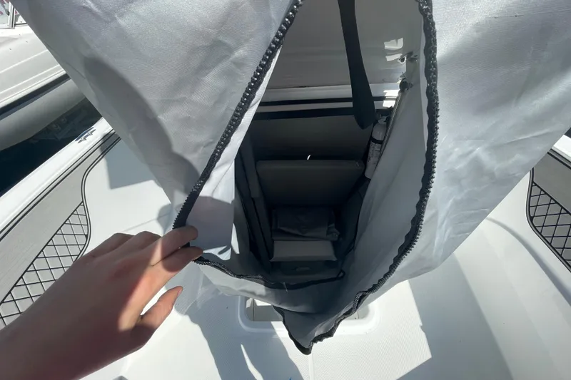 Slide: The Image of 2022 Wellcraft 202 Fisherman boat interior with storage compartment and safety equipment. - 8