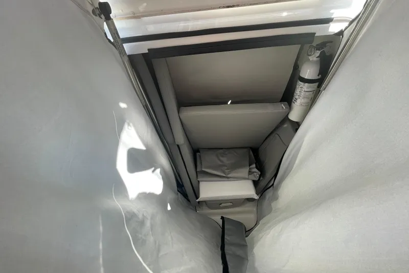 Slide: The Image of Interior view of 2022 Wellcraft 202 Fisherman boat, featuring storage and safety equipment. - 9