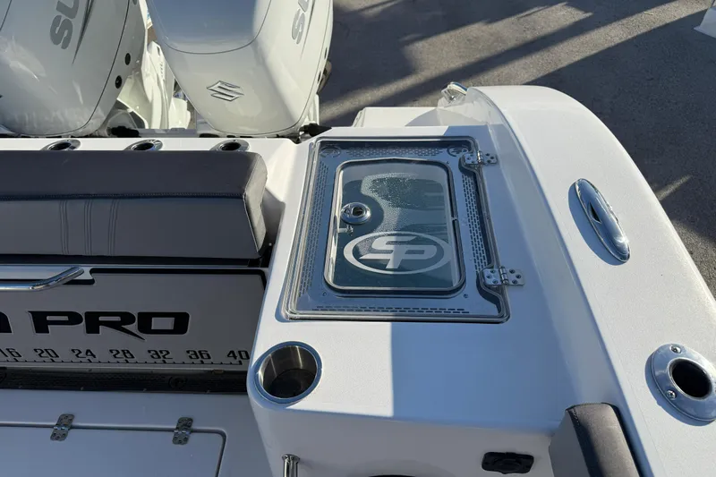 Slide: The Image of 2026 Sea Pro 292 DLX boat deck with Suzuki engines and livewell. - 10