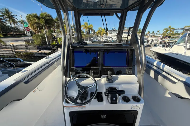 Slide: The Image of 2026 Sea Pro 292 DLX boat dashboard with dual screens and steering wheel. - 17