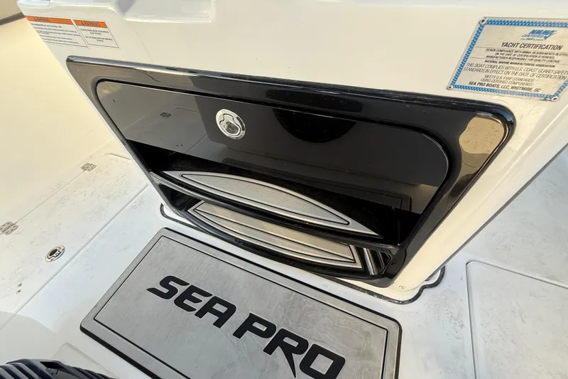 Slide: The Image of 2026 Sea Pro 292 DLX boat interior with storage compartment and yacht certification label. - 19