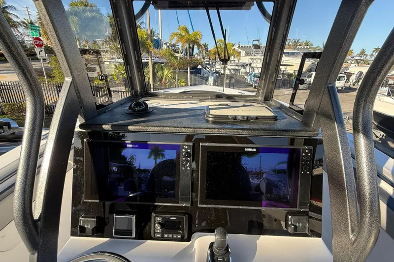 Slide: The Image of 2026 Sea Pro 292 DLX boat dashboard with dual Simrad displays and modern controls. - 23