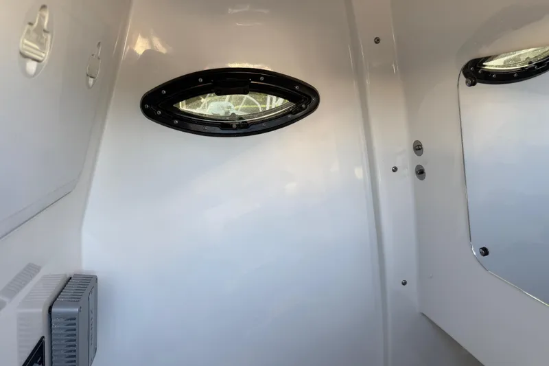Slide: The Image of Interior view of 2026 Sea Pro 292 DLX boat cabin with porthole window. - 28