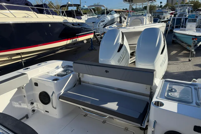 Slide: The Image of 2026 Sea Pro 292 DLX boat with dual engines, docked among other boats. - 3