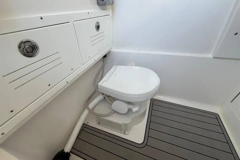 Slide: The Image of 2026 Sea Pro 292 DLX boat bathroom with toilet and storage compartments. - 30