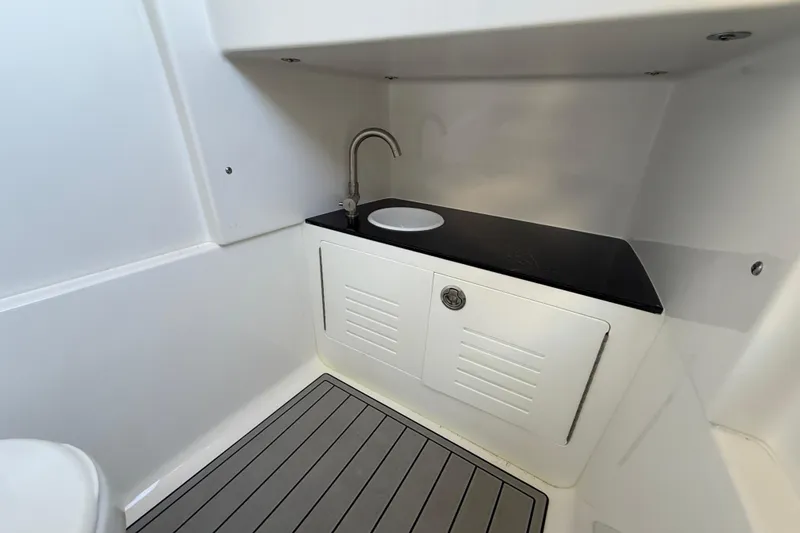 Slide: The Image of 2026 Sea Pro 292 DLX boat interior with sink and storage cabinet. - 31