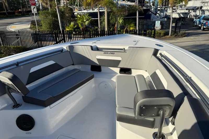 Slide: The Image of 2026 Sea Pro 292 DLX boat interior with gray seating and modern design. - 33