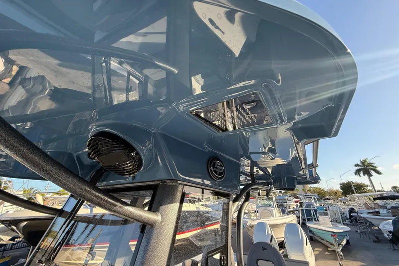 Slide: The Image of 2026 Sea Pro 292 DLX boat with sleek design and modern features, docked under clear sky. - 44